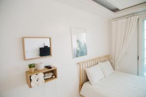 a bedroom with a bed and a mirror and a window at Taean Sharon Pension in Taean