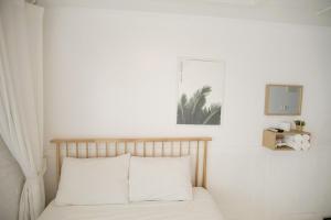 a bedroom with a bed with white sheets and a mirror at Taean Sharon Pension in Taean +10 photos
