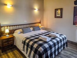 a bedroom with a bed with two pillows on it at Posada La Solana Santillana del Mar in Santillana del Mar
