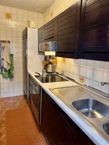 a kitchen with a sink and a counter top at Casa Vacanza Caspoggio in Caspoggio +36 photos