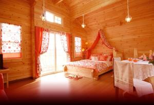 a bedroom with a bed in a wooden cabin at dagagada pension in Hwach'ŏn +5 photos
