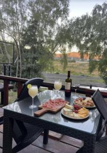 a picnic table with a bottle of wine and food at Cabañas San Pedro in Concepción