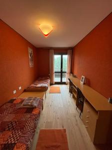a room with two beds and a desk in it at Casa Vacanza Caspoggio in Caspoggio