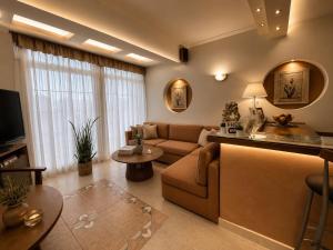 a living room with a couch and a table at Hotel Dionysis Studios in Adamantas