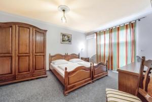 a bedroom with a bed and a wooden cabinet at Terano Urban Lodge in Maribor in Maribor +22 photos