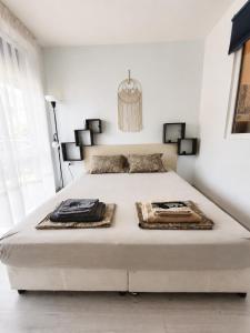 a white bedroom with a large bed in a room at Decor in Atlantis Resort&SPA by RV Apartments in Burgas +20 photos