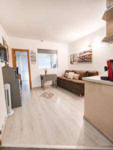 a living room with a couch and a table at Decor in Atlantis Resort&SPA by RV Apartments in Burgas