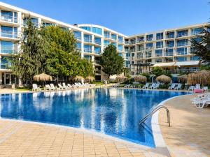 a large swimming pool in front of a hotel at Decor in Atlantis Resort&SPA by RV Apartments in Burgas