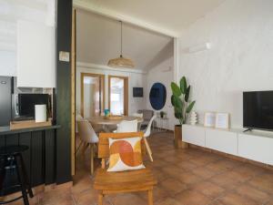 a kitchen and living room with a table and chairs at Oasis Beach Holiday Home with jacuzzi in Playa del Ingles