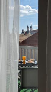 a table with food and drinks on a balcony at LEO Apartman in Veszprém