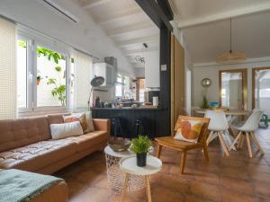 a living room with a couch and a table at Oasis Beach Holiday Home with jacuzzi in Playa del Ingles