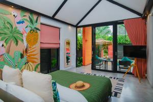 a room with a bed and a tv in it at Tolani Resort Koh Samui in Lamai