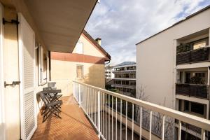 a balcony of a house with a chair on it at Pixner Apartments in Bolzano