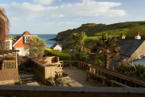 a balcony with a view of the ocean at Lulworth Lodge in Lulworth Cove