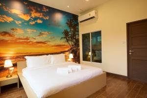 a bedroom with a large bed with a sunset mural at Rocco Hotel Bangsaen in Ban Laem Thaen