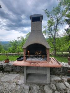 a stone oven with a fire inside of it at Guesthouse Loncar in Plitvička Jezera
