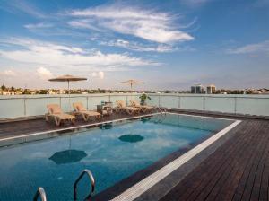 a swimming pool on the roof of a building at The Lynora in Mysore