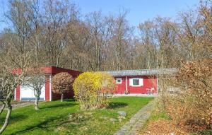 a red house in the middle of a yard at Cozy Home In Sölvesborg With Wifi in Sölvesborg