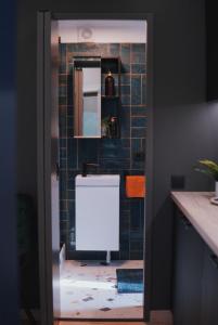 a bathroom with a sink and a mirror at Riverside weekend cabin in Upesciems