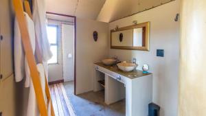 a bathroom with two sinks and a mirror at Windhoek Game Camp in Lafrenz Township +73 photos