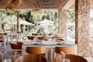 a restaurant with tables and chairs and trees at Casa Solea in Barbati
