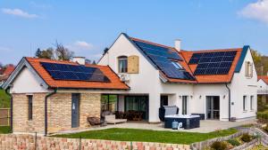 a house with solar panels on the roof at Pannon Grace Balaton in Dörgicse