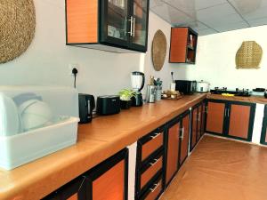 a kitchen with a wooden counter top with appliances at Slow Life Coliving, Hiriketiya in Dickwella +56 photos