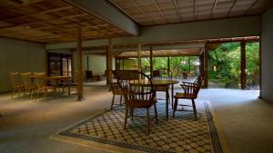 a dining room with a table and chairs at Yakakutei in Kirishima