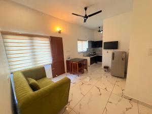 a living room with a couch and a kitchen at Zensta Residency in Cochin