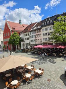 a city square with tables and chairs and buildings at Modernes Apartment im Herzen der Ravensburger Altstadt in Ravensburg