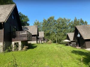 a group of houses with a grass yard at Chaty u Martiny in Nalžovice