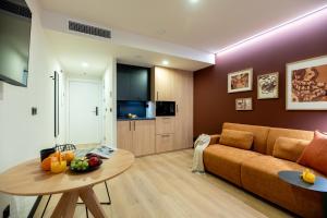 a living room with a couch and a table at VORS&Co Jerez in Jerez de la Frontera +66 photos