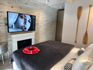 a bedroom with a tv above a fireplace and a bed at NOBILTON Dębki in Dębki