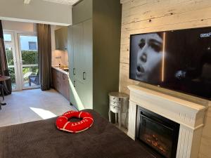 a living room with a fireplace and a flat screen tv at NOBILTON Dębki in Dębki +46 photos