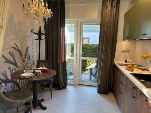 a kitchen with a table and a dining area with a window at NOBILTON Dębki in Dębki