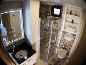 a small bathroom with a shower and a sink at BUTİK 24 SUİTES in Ankara +32 photos