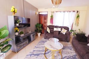 a living room with a couch and a table at The Nest Apartment Darad in Ukunda Airport