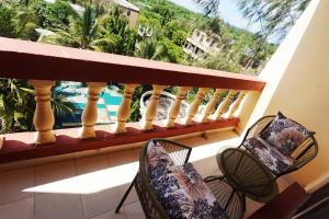 a balcony with two chairs and a view of the ocean at The Nest Apartment Darad in Ukunda Airport