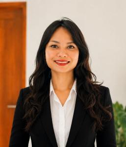 a woman in a suit smiling at the camera at Lemon Tree Hotel Bali in Lovina