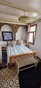 a bedroom with a large bed and a window at Dar Nomads in Chefchaouen