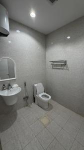 a bathroom with a toilet and a sink at Apartment in Al Kharj