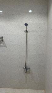 a shower with a shower head in a bathroom at Apartment in Al Kharj