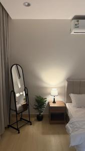 a bedroom with a chair and a lamp next to a bed at Apartment in Al Kharj