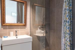 a bathroom with a sink and a mirror at Le Refuge in Patrimonio +24 photos