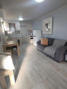 a living room with a couch and a table at Kindred Studio Apartments in Leeton +18 photos