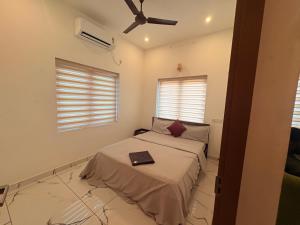 a bedroom with a bed and a ceiling fan at Zensta Residency in Cochin