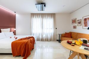 a hotel room with a bed and a couch at VORS&Co Jerez in Jerez de la Frontera