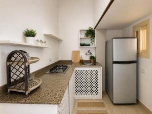 a kitchen with a refrigerator and a counter top at Tranquilo Boutique Hostel - Dahab in Dahab