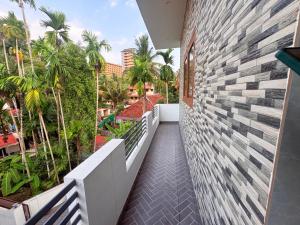 a balcony of a house with a brick wall at Zensta Residency in Cochin