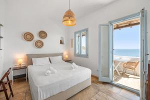 a bedroom with a bed and a view of the ocean at Sea view rooms in kardiani by TinosStay in Kardhianí